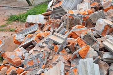 Close-up of piles of red brick rubble and cement