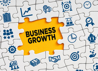 Business growth concept. The word business growth in a missing puzzle piece with business symbols.