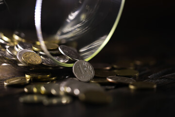 Obraz premium Russian rubles and metal coins inside a glass jar close-up on black blurred background