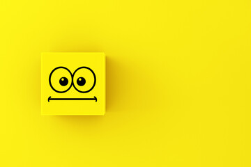 Neutral or surprised emoticon face on a yellow cube block.