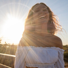 Young cheerful girl smiling at sunset - 646701731