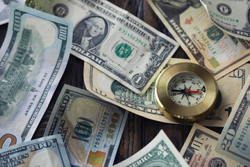 Money bill with golden Compass. Bullets and cartridge cases as a military concept. Close up US Currency and compass. business, financial idea, concept, symbol of crisis, inflation