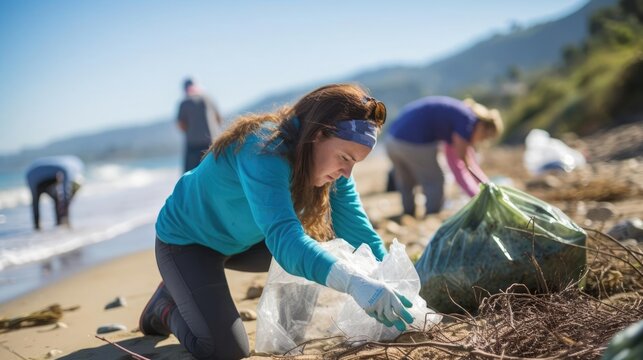 Candid scene of volunteers demonstrating commitment and teamwork while participating in a beach cleanup