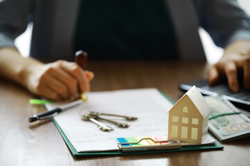 Real estate agent talked the terms of the home purchase agreement and asked the customer to sign the documents, Home sales and insurance concept.