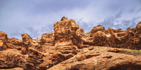 Fototapeta premium Red rock wall of the Charyn canyon in the national park of the Almaty region. Picturesque nature of middle asia.