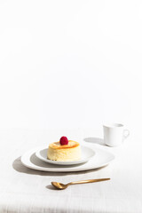 Cheesecake with Raspberry Jam and Coffee on a Minimalist Table, White Background with Text Space