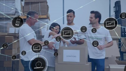 Animation of network of digital icons over team of diverse volunteers keeping items in donation box