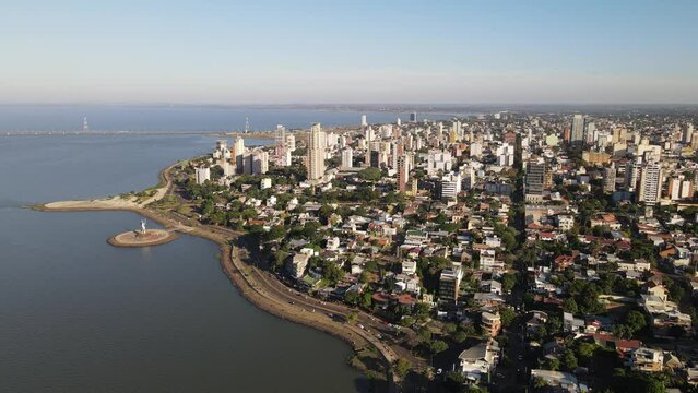 Aerial view of the coastal city of Posadas Misiones Argentina, drone shot of densely populated coastal city cloudy sky