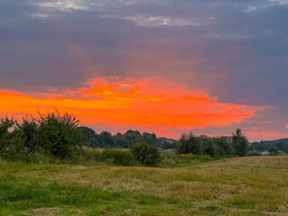 A picturesque scene capturing the rustic charm of a straw-strewn field basking in the warm, golden hues of the sun.