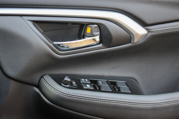 Obraz na płótnie Canvas Door handle and window controls of a modern vehicle