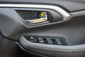 Naklejka premium Door handle and window controls of a modern vehicle