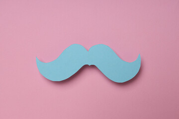 Blue paper mustache on a pink background, Movember concept
