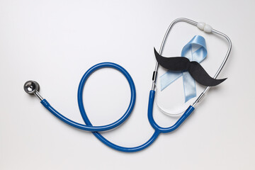 Stethoscope with paper mustache and blue ribbon, Movember concept