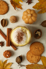 Pumpkin coffee, leaves and cinnamon on white background, top view