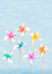 Obraz premium 水彩で描いた青空をバックに配した7本のカラフルな風車