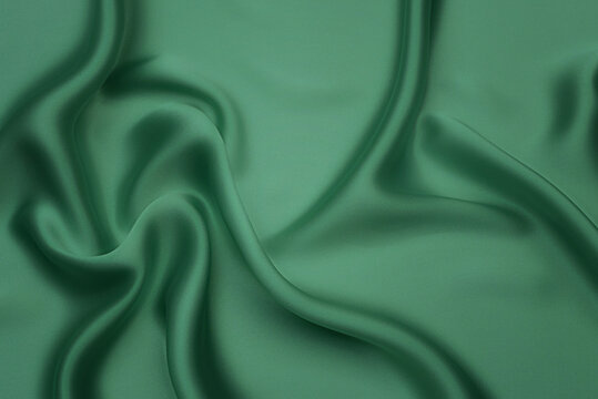 Texture, background, pattern. Texture of green silk fabric. Beautiful emerald green soft silk fabric.
