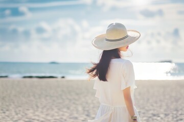 Fototapeta na wymiar Woman in summer vacation wearing straw hat enjoying the view at the ocean. Back view. Generative Ai