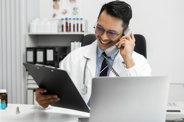 Male medicine doctor, physician or practitioner involved in cellphone call conversation giving professional consultation to patients. Medic tech concept.