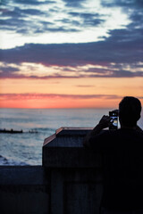 Fototapeta na wymiar person watching sunset cromer 
