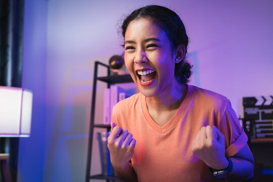 Young Asian woman open mouth with emotional excited and shocked with winning, celebrating victory expressing success.
