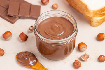 Chocolate paste with nuts in a jar. Dessert. Vegetarian food.
