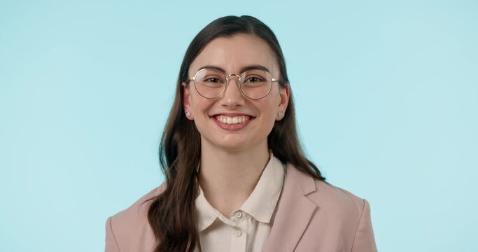 Wink, flirt and face of woman with glasses in studio with confidence, good mood or gesture on blue background. Nerd, portrait and female model with eyeglasses, goofy or silly expression with emoji