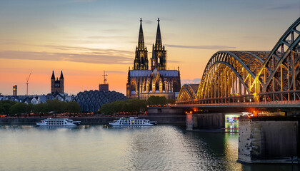 Cologne skyline at sunset with view of Cologne Cathedral and Hohenzollern Bridge, North Rhine-Westphalia, Germany