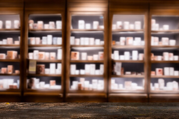 Dark Wooden Counter with Blurred Pharmacy Shelves ideal for product presentations or mockups.
