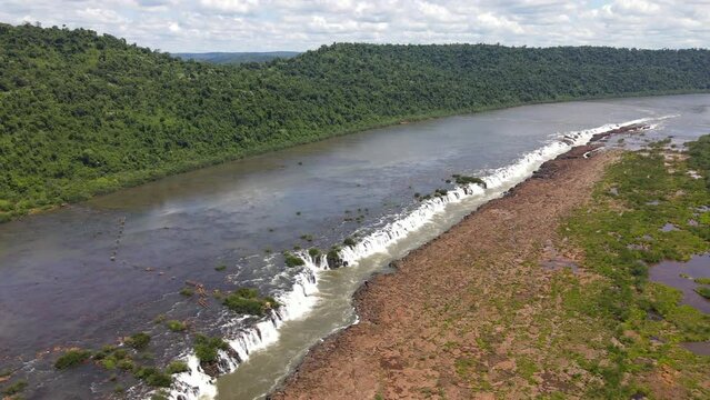 A lateral drone view of Mocon&aacute; Falls on a clear day, showcasing the stunning longitudinal waterfalls