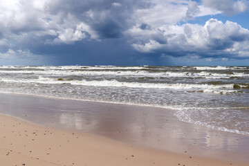 Baltic Sea coast and wild beach with rain clouds on the horizon, Poland - 646749909