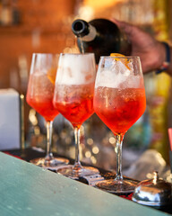 Spritz traditional cocktail with alcohol being prepared in a beach bar. Italian drink. Lifestyle concept