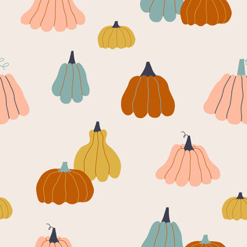 Seamless autumn pattern with different multicolored pumpkins.