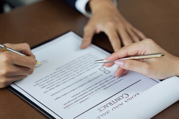 Close up image of businessman hand putting personal signature on contract document
