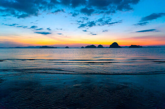 Background image of the colorful seascape in summer time. Beautiful sunset sky over the low tide at tropical beach in the evening with filter. copy space. Tup Kaek Beach, Krabi, South of Thailand.