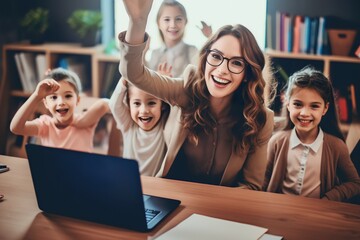 female teacher and student kids watching video together with laptop talking and laughing at class