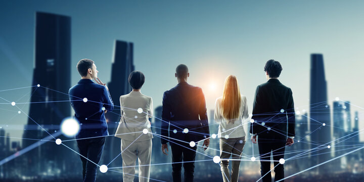 Group of people standing in front of futuristic city and communication network concept. Wide angle visual for banners or advertisements.