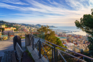Panoramic view of Sanremo or San Remo from Pigna hill, Italian Riviera, Liguria, Italy. Scenic sunset landscape with city architecture, sea, green hills, blue water and sky, outdoor travel background - obrazy, fototapety, plakaty