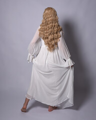 Full length portrait of blonde woman  wearing  white historical bridal gown fantasy costume dress....