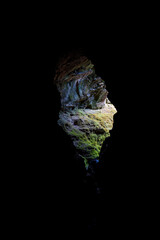 Hikers Emerging from a Cave into Daylight, Framed by Darkness