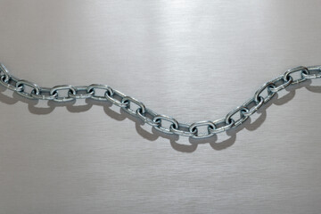 White metal customized chain with shadow placed on silver surface