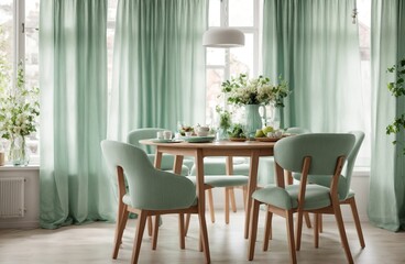 At a round wooden dining table in front of a window with light green and white drapes, there are two chairs in a mint color. Modern dining room  interior design