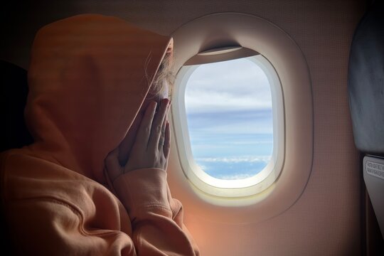 Portrait of scared young woman in airplane. phobia of flying on airplanes