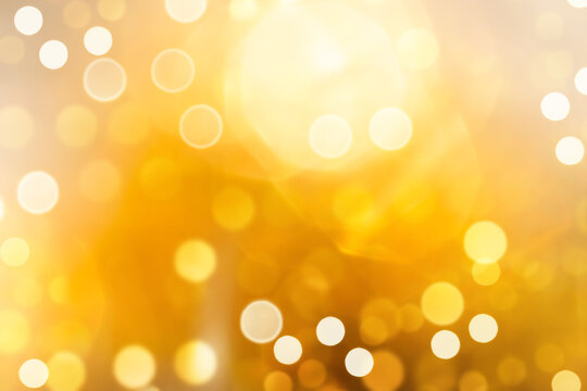 Bright yellow defocused light background for Christmas. Lens flare from bright light.