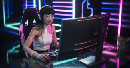 Fototapeta na wymiar Young Online Gamer Playing Video Game in a Futuristic Cyberpunk Room. Cosplay Girl Using Headphones, Talking with Players During the Game Stream. Pro Gamer Winning an Intense Round and Celebrating
