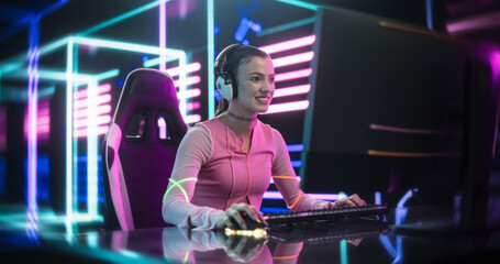 Young Female Gamer Playing Online Video Game on a Computer in a Cyberpunk Digital Neon World. Cosplay Girl with Stylish Colorful Make Up Streaming Futuristic Entertainment Content for Internet Viewers