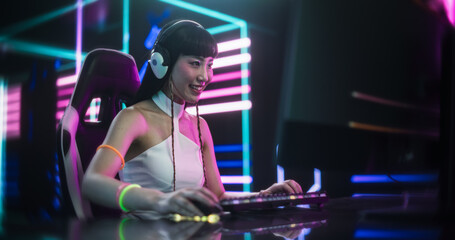 Excited Japanese Cosplay Girl Playing Video Games with Friends on a Computer, Surrounded by Cyberpunk Style Background. Concept of Internet Streaming, Gaming, Streaming and Social Network