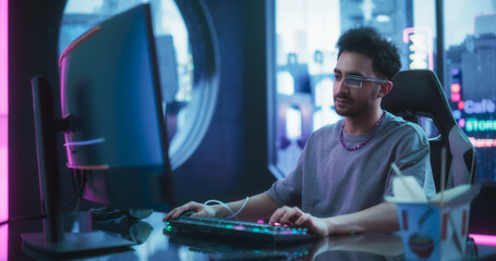 Software Developer Wearing Sci-Fi Monocle with Augmented Reality and Artificial Intelligence Functions. Young Handsome Man Working on a Computer in a Futuristic Cyber Reality Agency Room