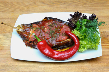 Crimean Tartar dish Imam Bajldy meat braised eggplant, stuffed with mutton and seasoned with parsley and tomato sauce, put on a tray. Coocked in Tartar restaurant