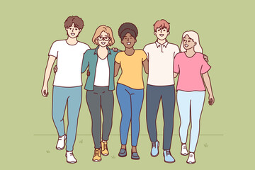 Multiracial people walk through park hugging and enjoying friendship with college classmates. Multiracial students walk together on grass and invite to become member of friendly university community
