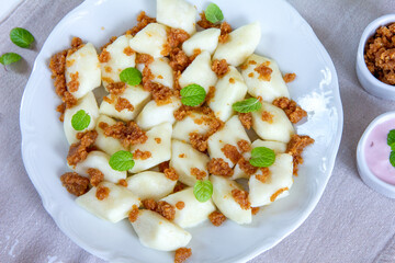 Lazy dumplings - a traditional Polish dish made of cottage cheese, potatoes, flour and eggs served with breadcrumbs fried in butter